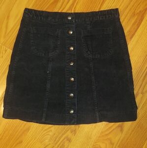 Brandy Melville mini corduroy black skirt snap button front closure.  Size small